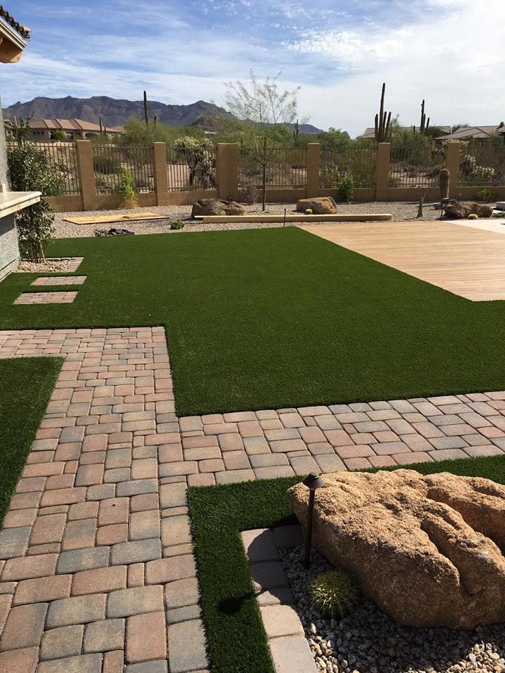  Artificial grass and paver installation in backyard. 