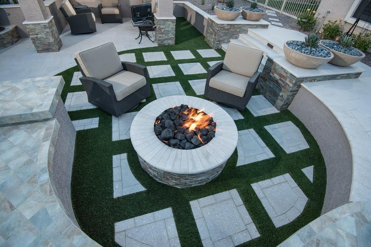  Artificial grass installed between paver patio sections to add visual interest and enhanced design. 