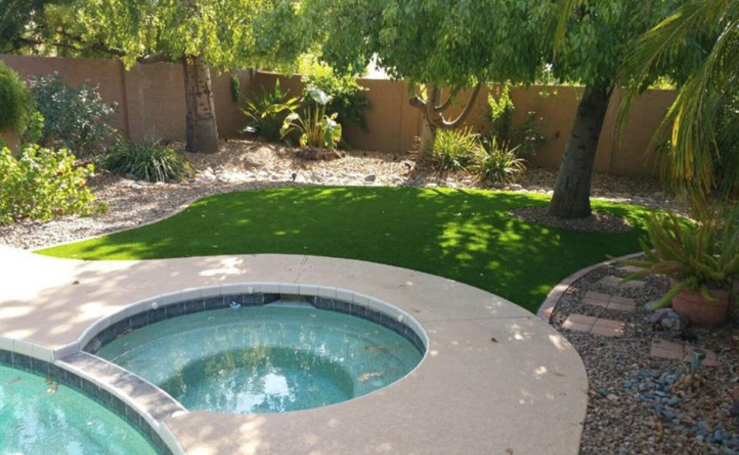  Artificial grass installed adjacent to hot tub 