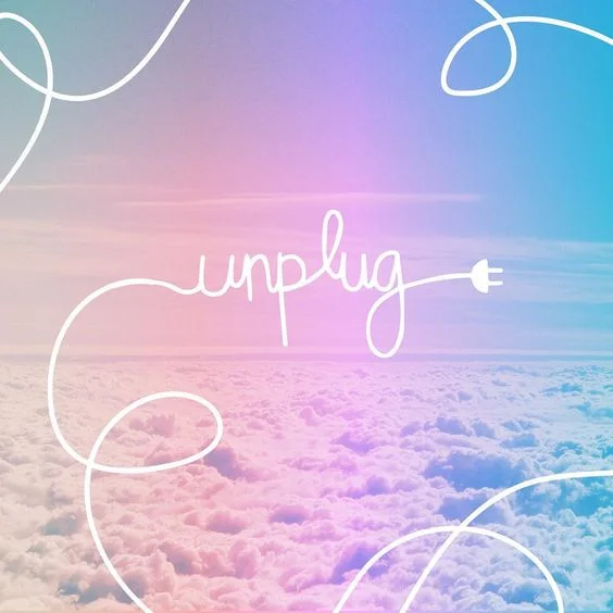A bird’s eye view of the clouds with the word “unplug” written with an unplugged cord.