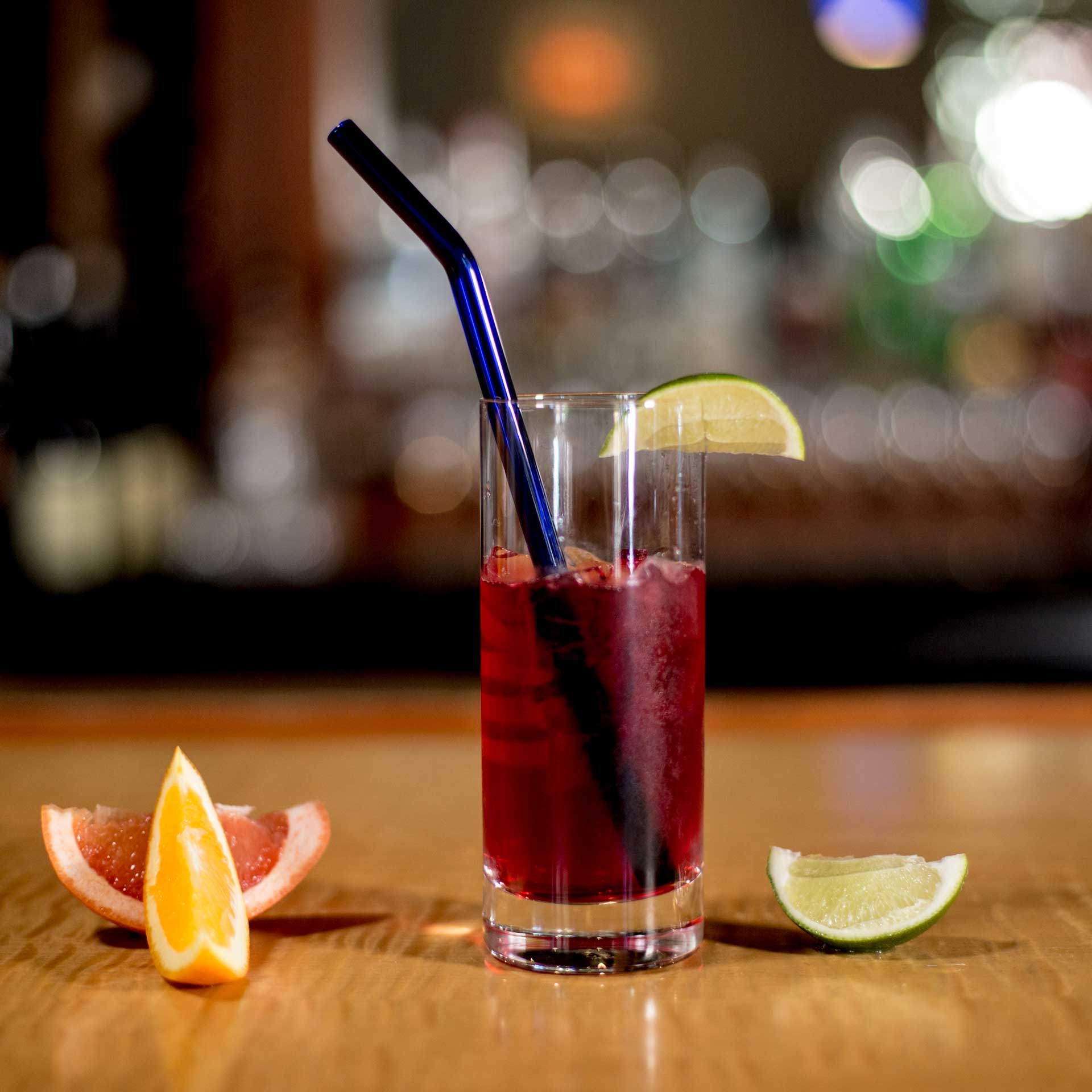 EcoGlassStraw_Bent_blue_lime_TallGlass_orange_Lemon_RedDrink.jpg
