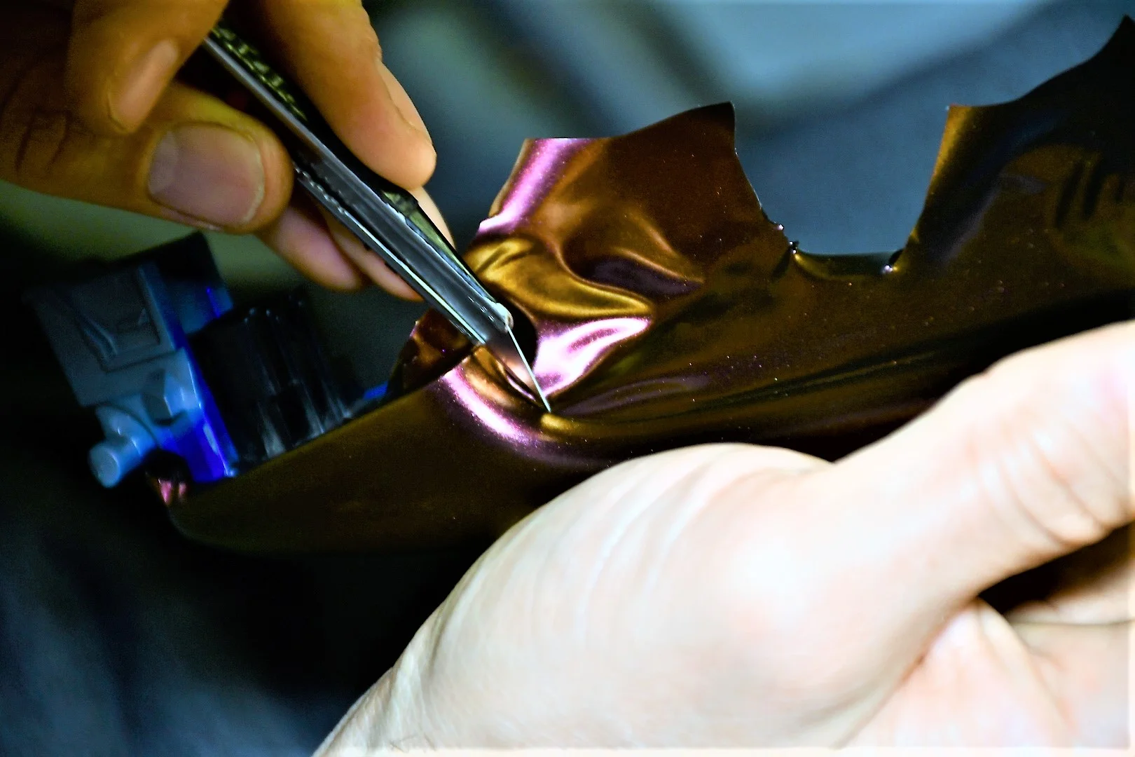 You want to angle your blade towards the excess end of the vinyl. You will need a small amount of vinyl leftover so you can tuck it into the seams.