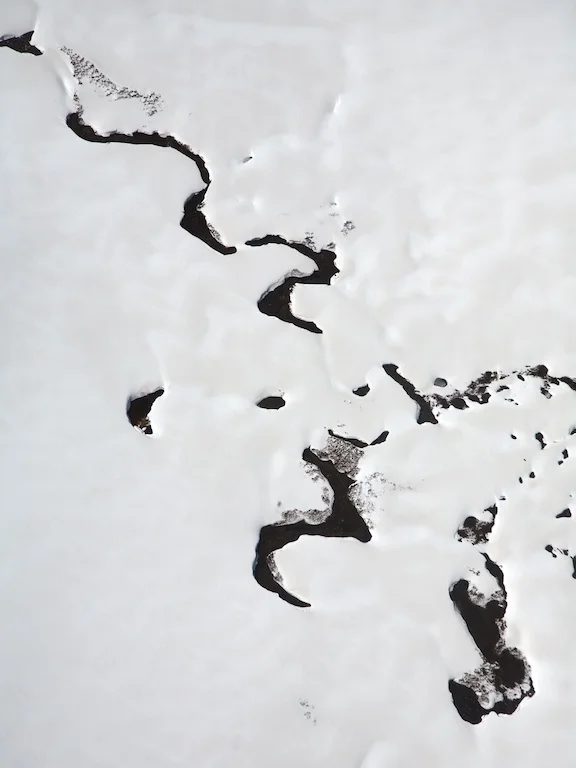 Creek emerging through snow, near Mt Hotham, Great Dividing Range, Victoria, 2007.