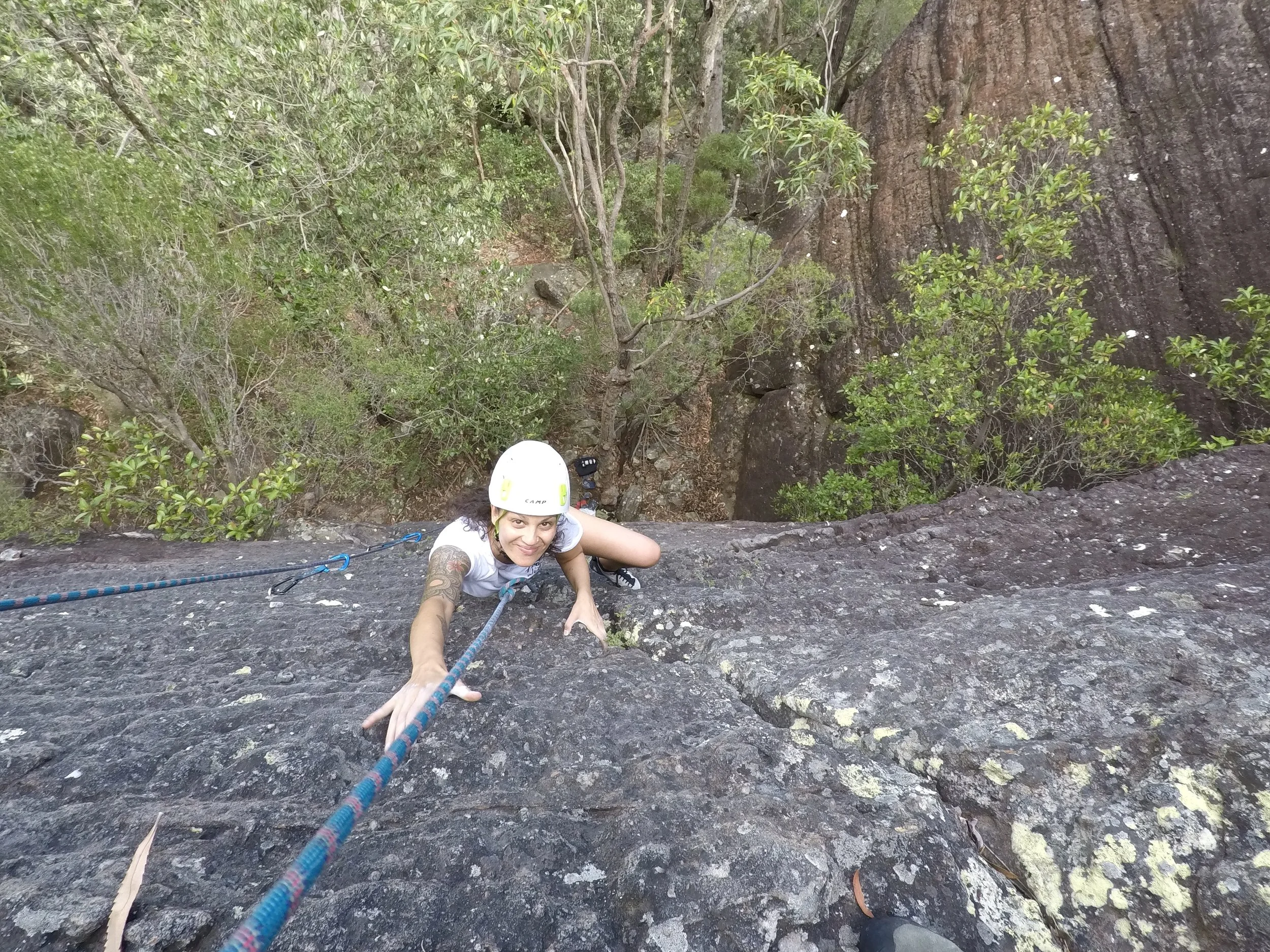 Climber scaling a cliff face during a guided outdoor rock climbing session in NSW with Big Nature Adventures