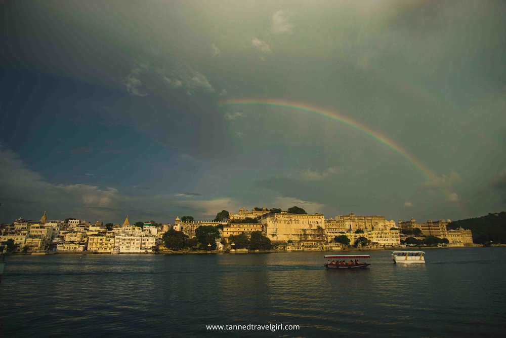 rainbow over city palace in udaipur