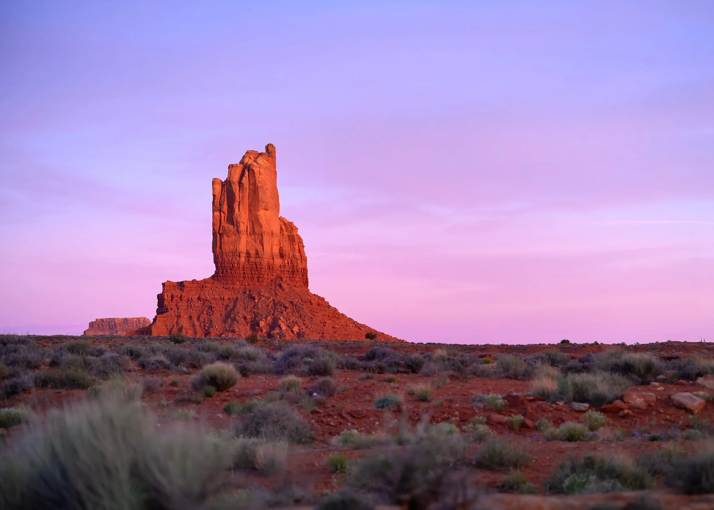 Sandstone tower in Ojlato-Monument Valley with pink and purple sunset