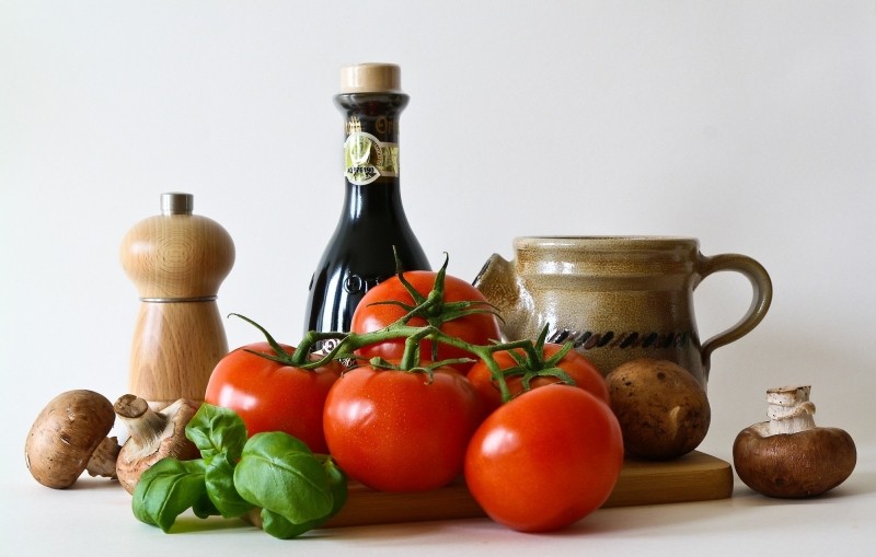 tomatos-and-bottle-of-oil-on-table.jpg