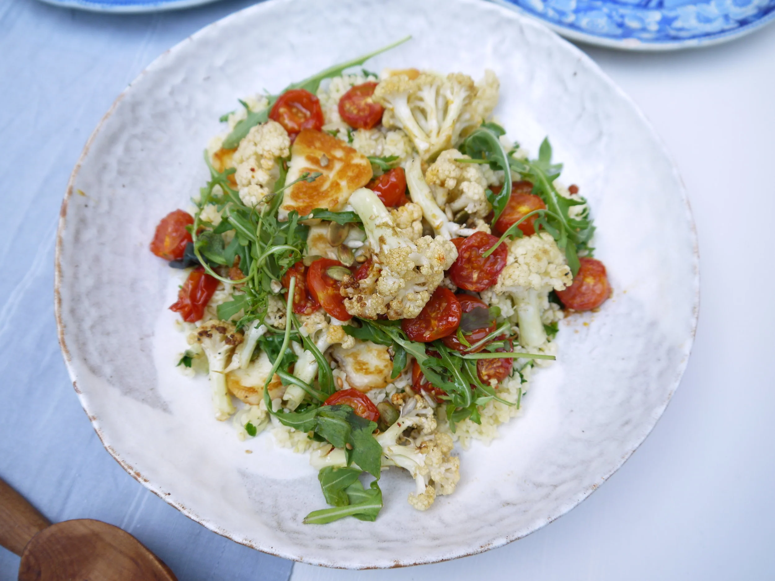 harissa tomatoes with cauliflower, halloumi and herbed bulgar