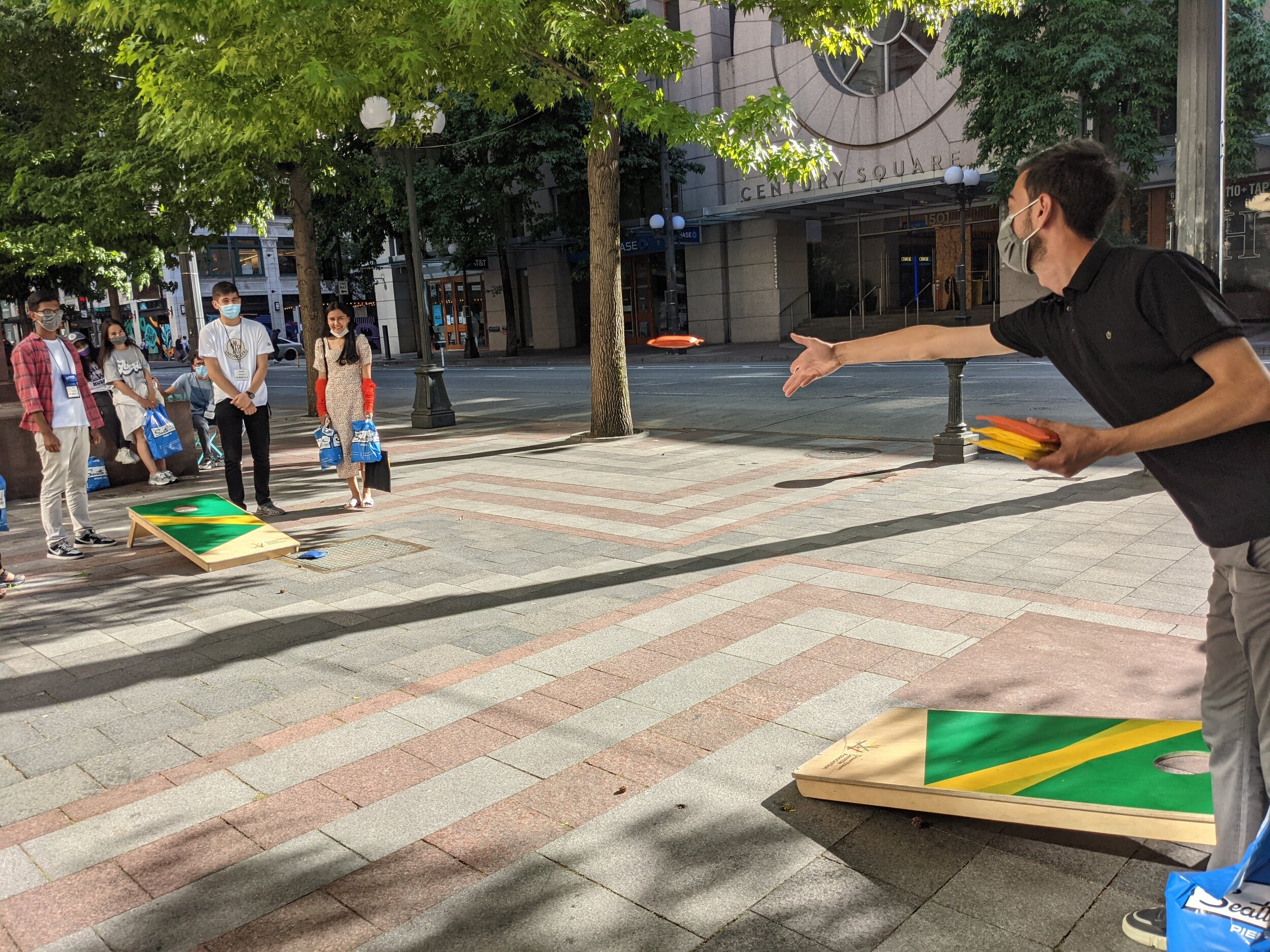 Participants learned to play cornhole in Westlake Park before going to dinner with their University of Washington "Ambassadors"