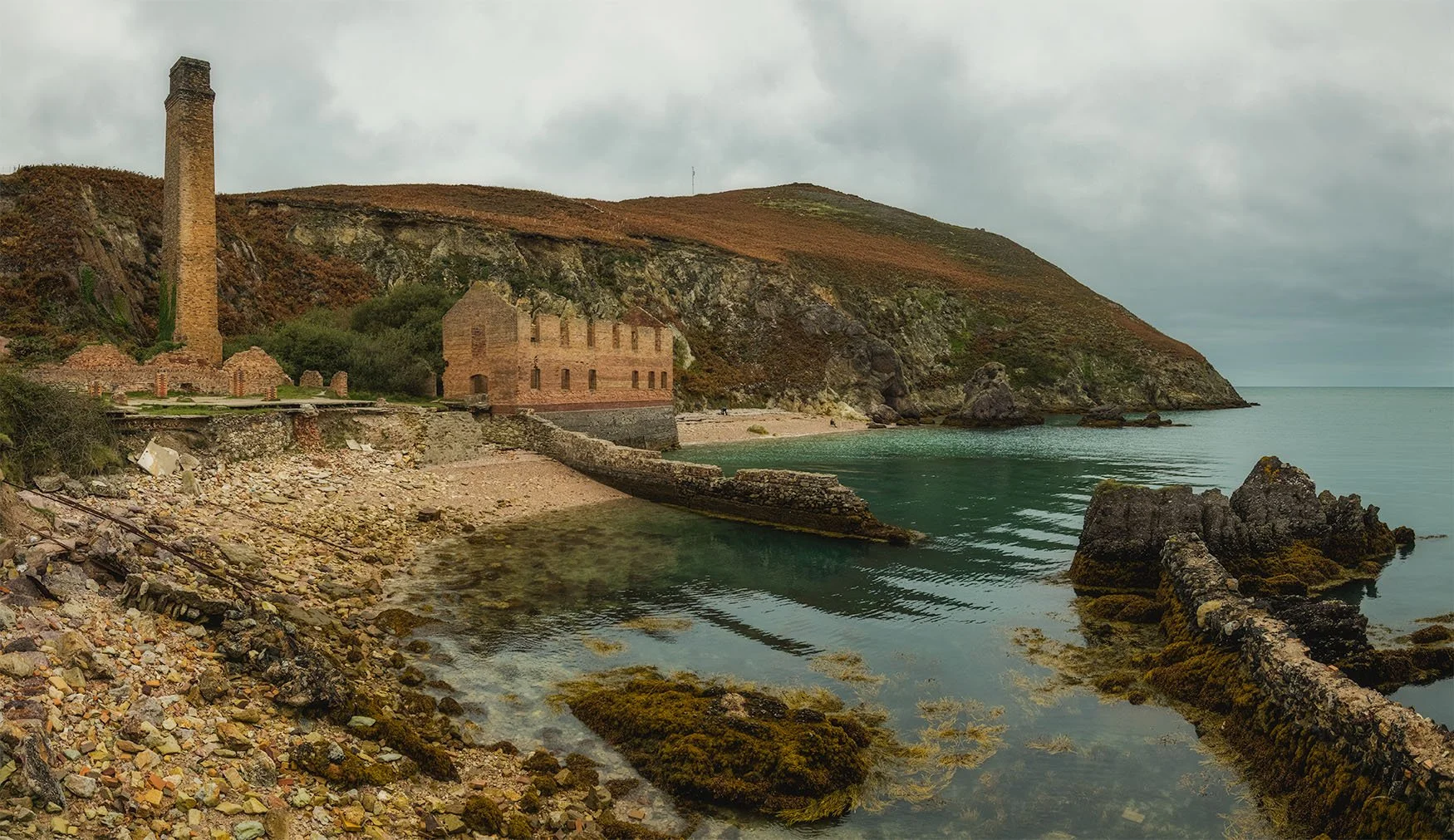  Looking down from the coastal path towards Porthwen Brickworks, Anglesey. The brick ruins meet the calm sea beneath moody skies — a timeless union of industrial heritage and Welsh coastline. 