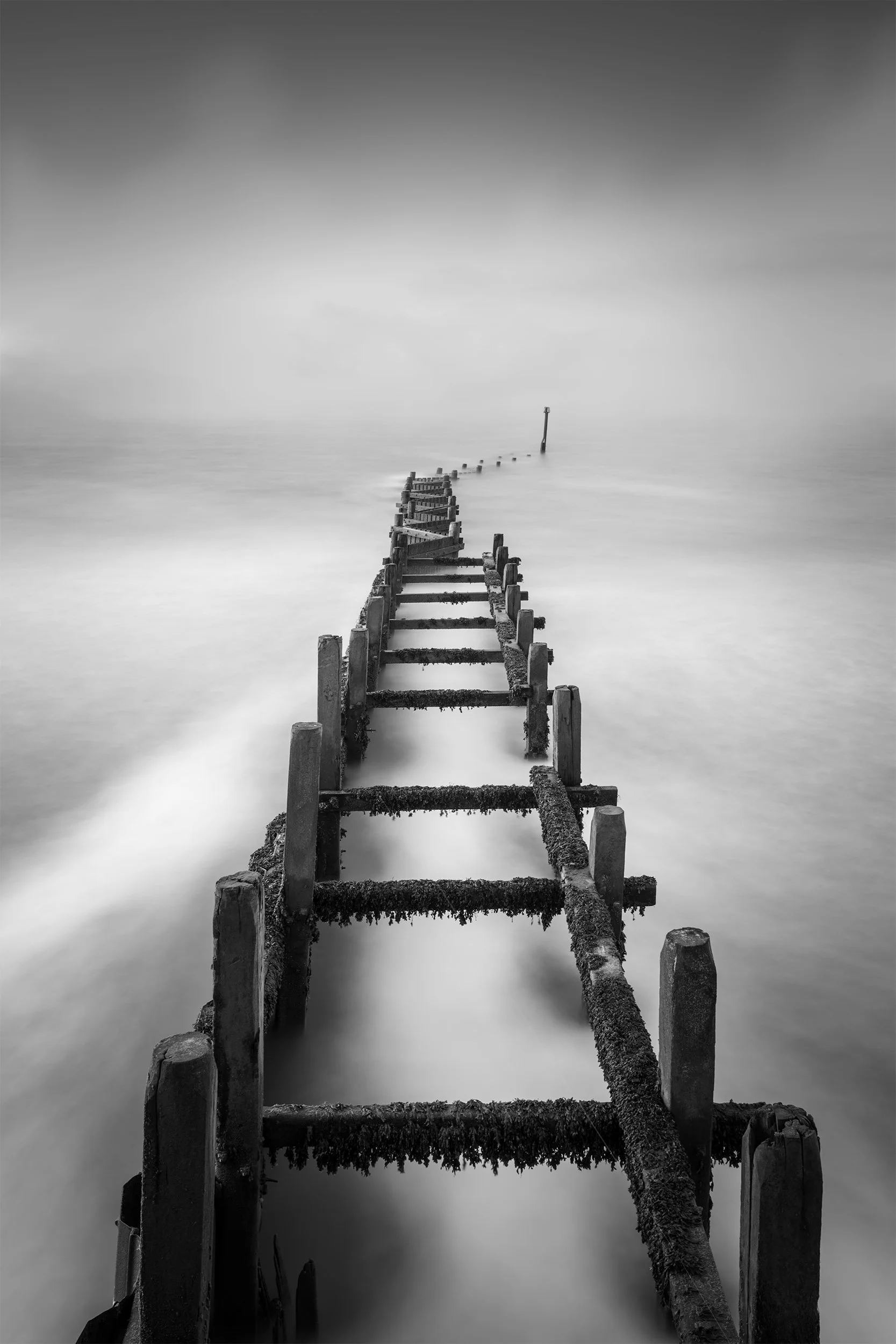 Black and White Fine Art Long Exposure photo of sea defences at Overstrand beach, Cromer, Norfolk, United Kingdom