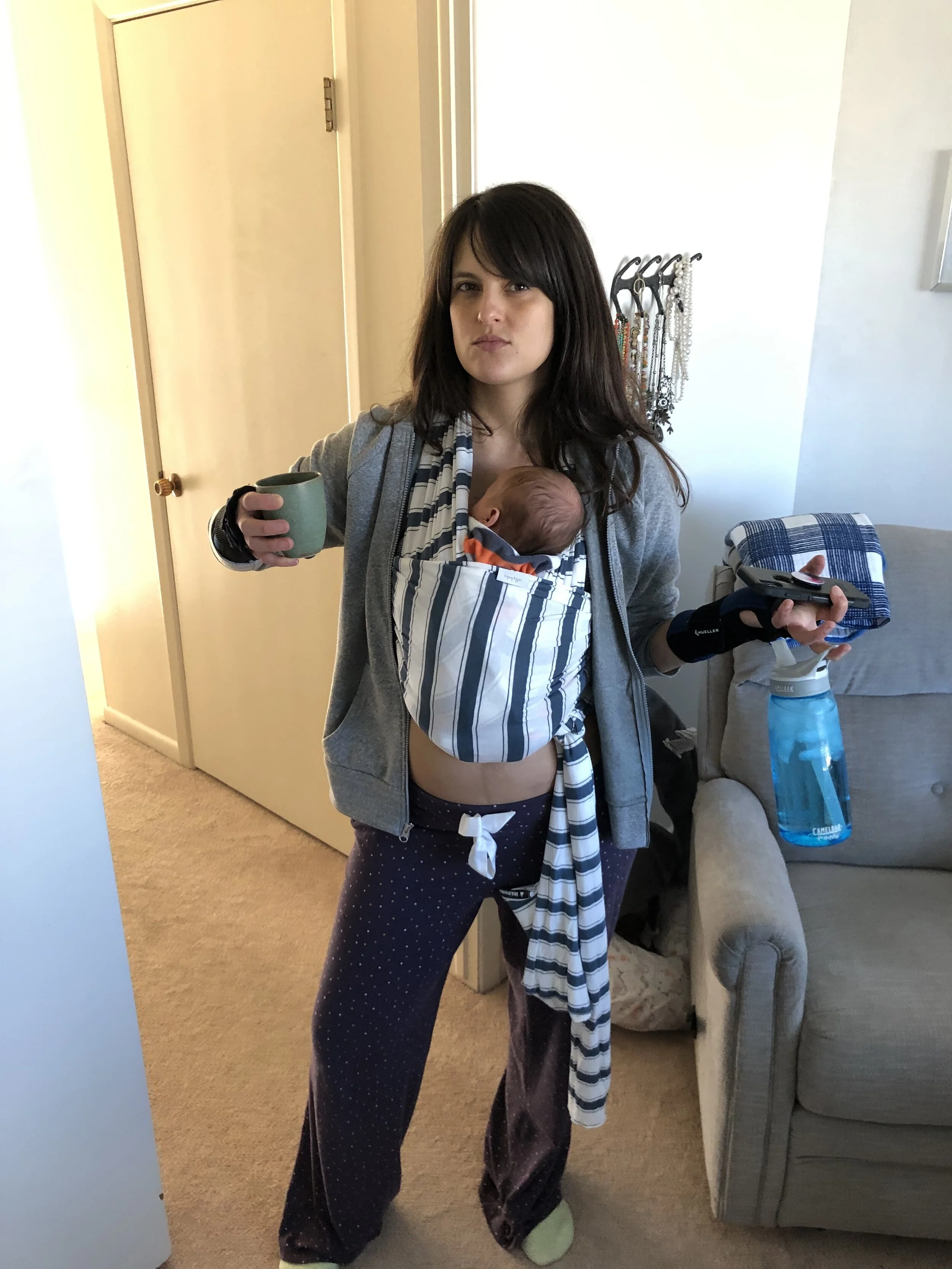 Multi-tasking mama: Cozy pajama pants…check! Zip-up sweatshirt…check! Cozy socks…check! Baby in sling…check! Coffee and water…check! Cell phone…check!
