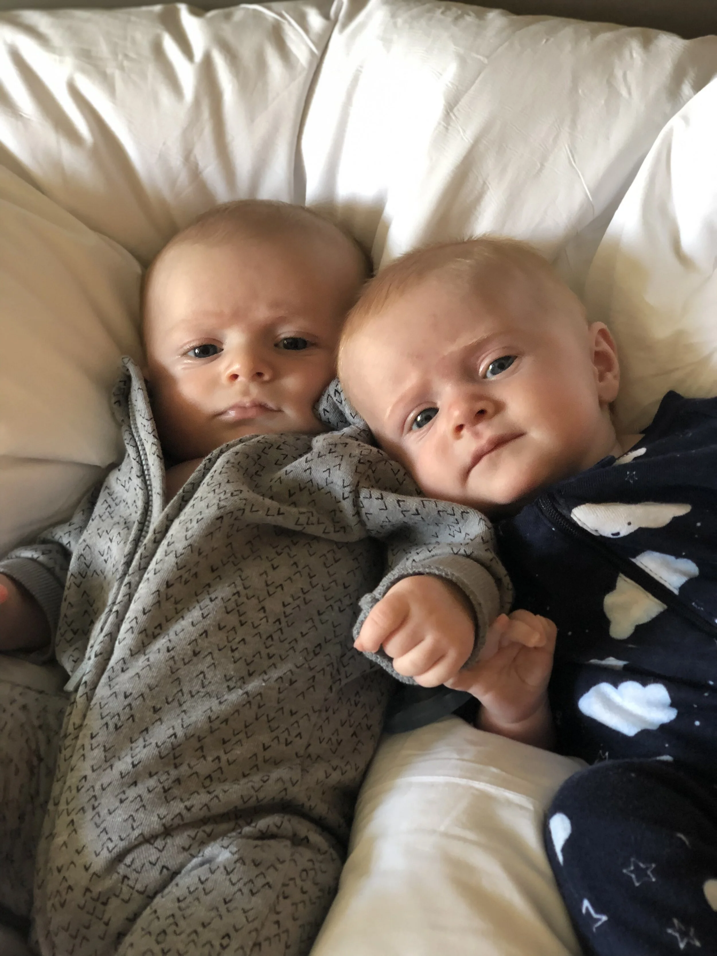 two babies hanging out on bed.jpg