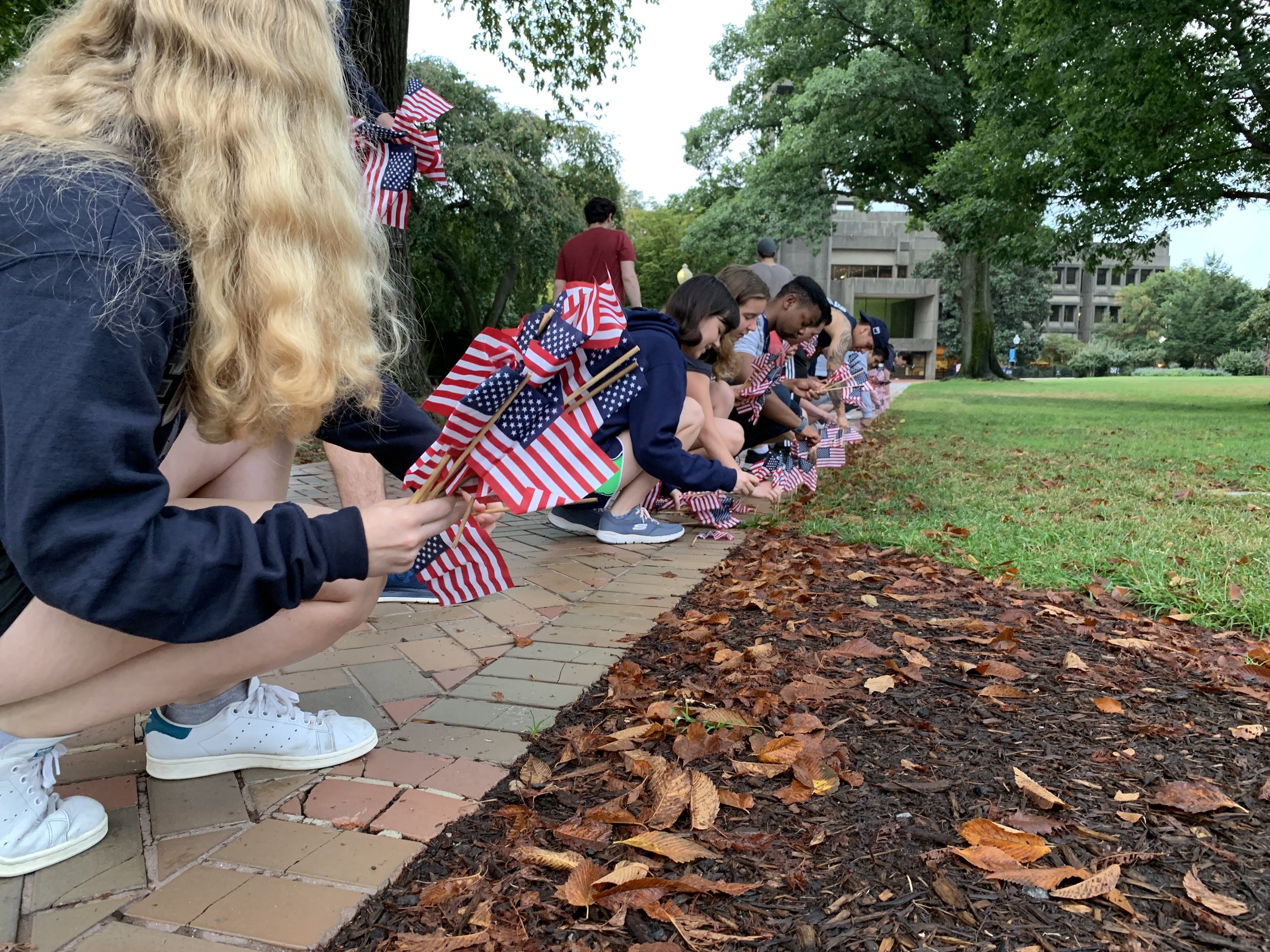 Georgetown students place American flags along campus sidewalks commemorating of the lives lost on the attacks of September 11, 2001. (9/11/2019)