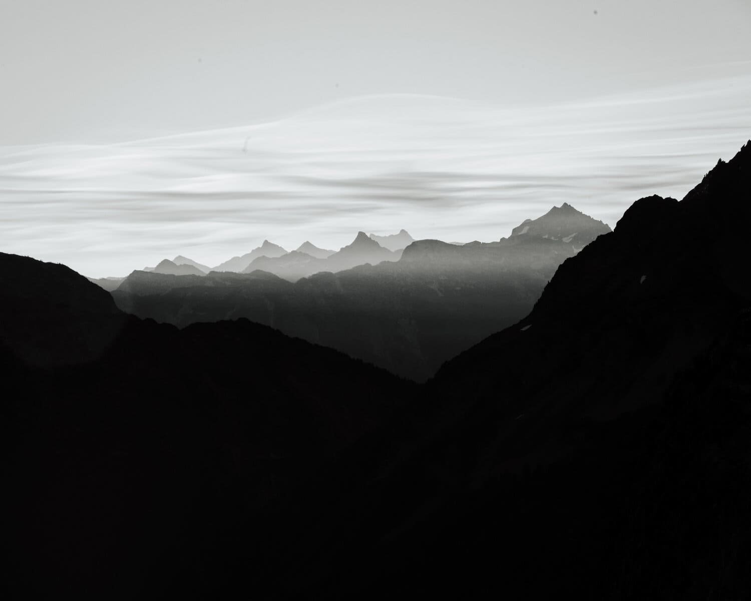 black and white mountain range with fog.jpeg