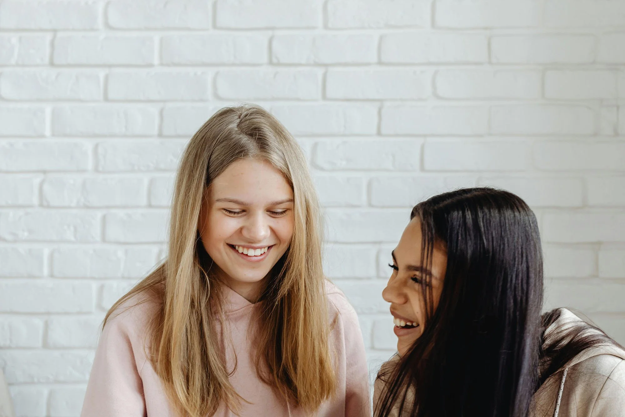 Two girls smiling together during child anxiety counseling in Davidson, North Carolina