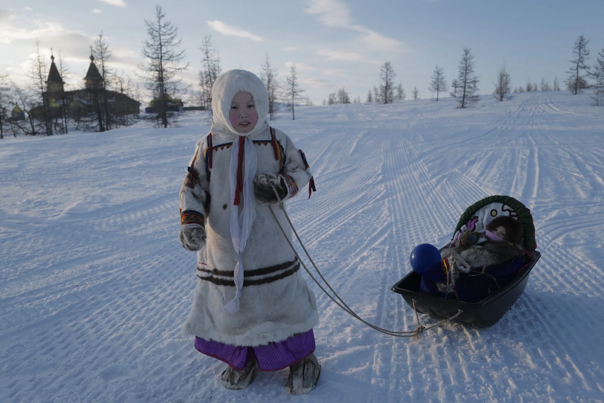 A Nenets schoolgirl pulling her baby sister in a sled-like pram. Photographed with Leica Q2, Siberia, 2019. © Rosalynn Tay.