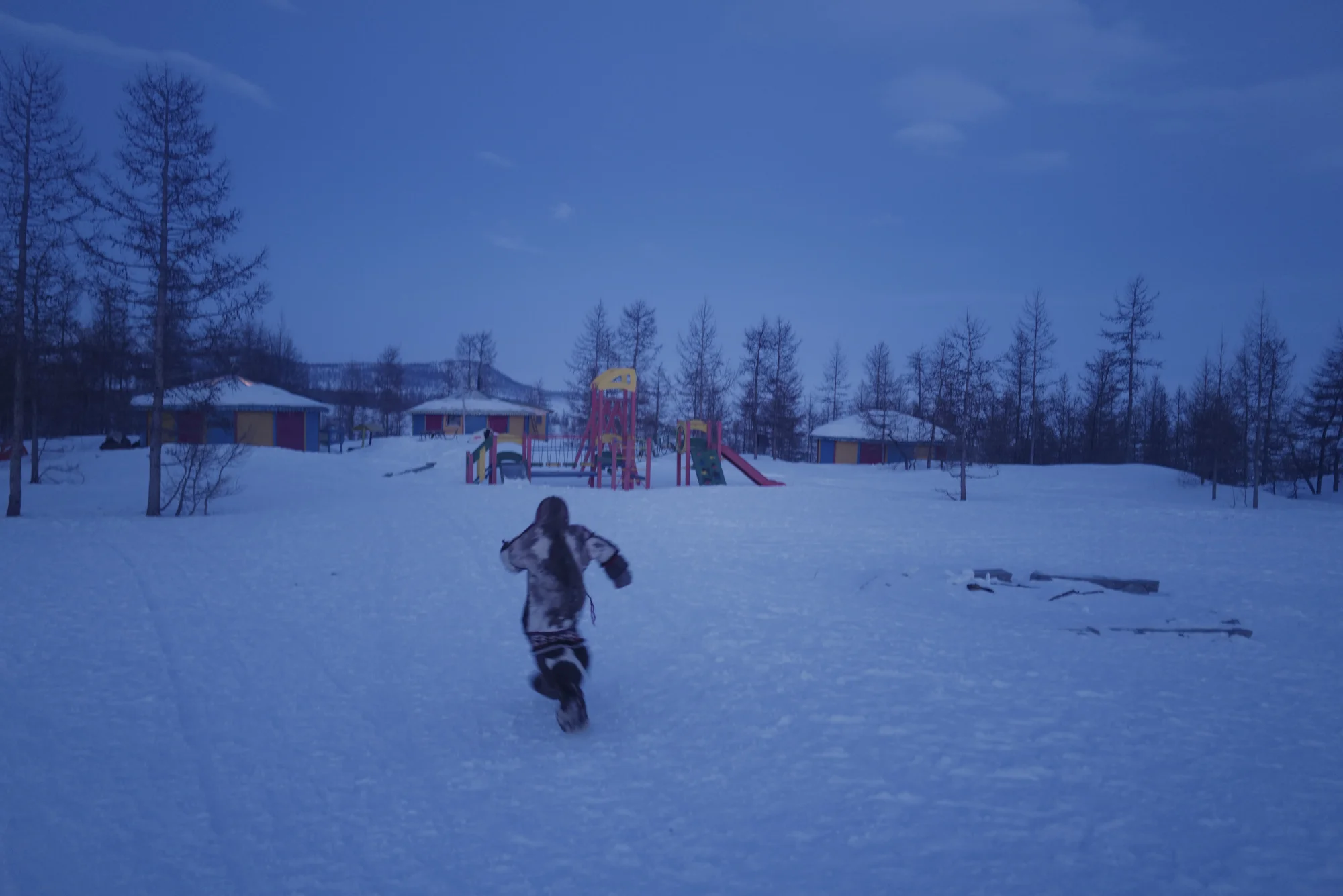 A Nenets school girl running home at blue hour. Photographed with Leica Q2, Siberia, 2019. © Rosalynn Tay.