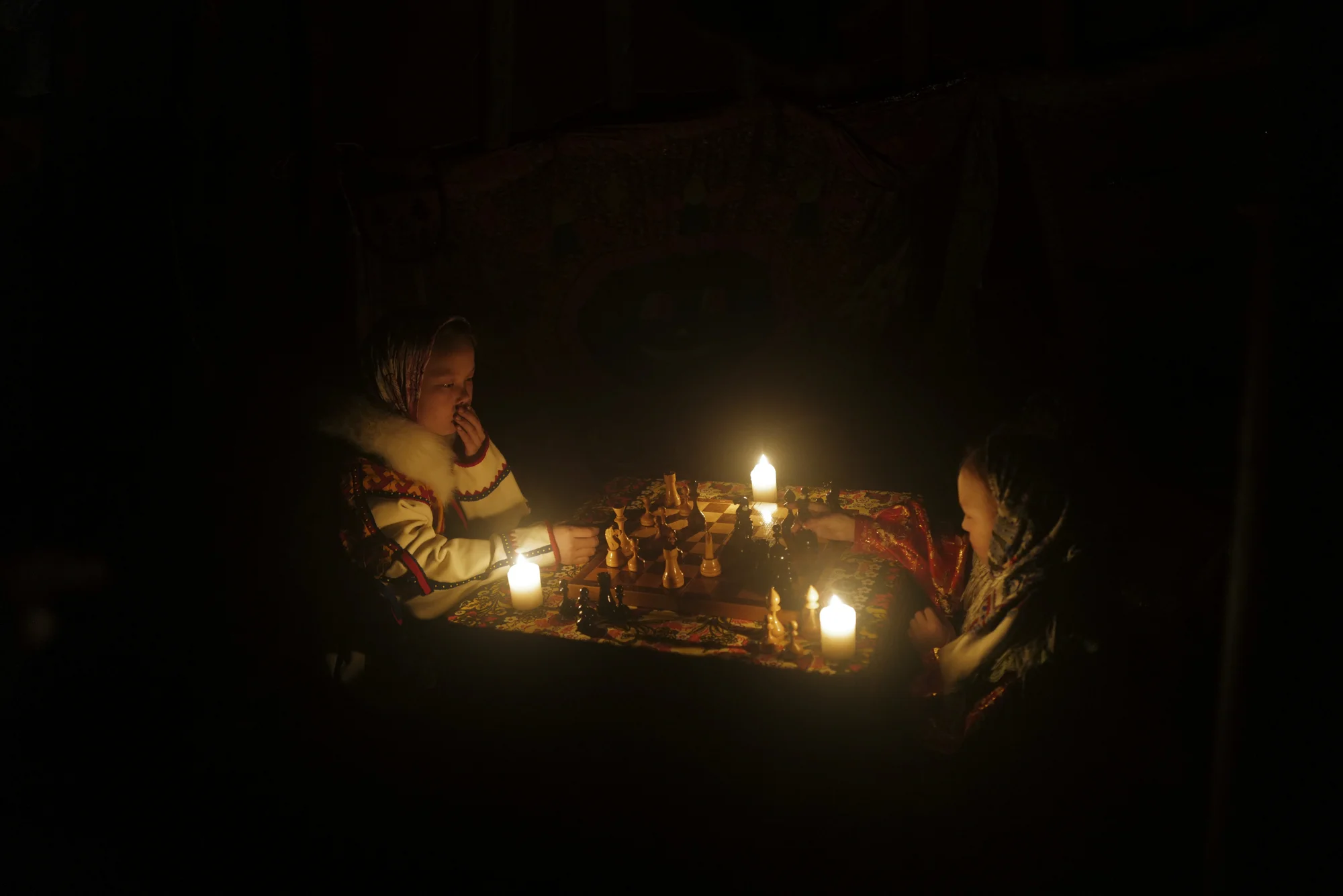 Two Nenets school children were playing Russian chess under the candlelight. Photographed with Leica Q2, Siberia, 2019. © Rosalyn Tay.
