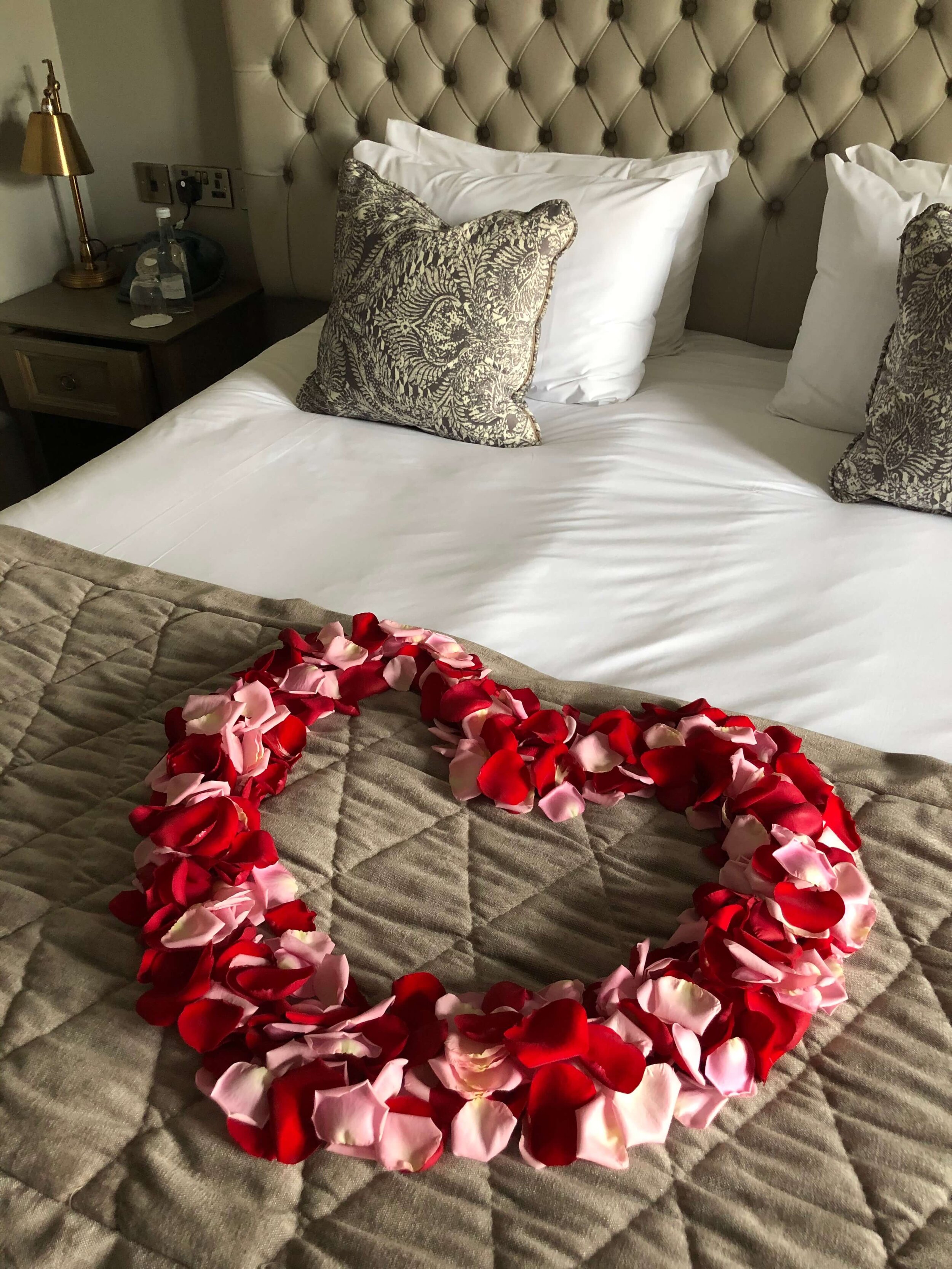Rose Petal heart on bed for proposal at hotel