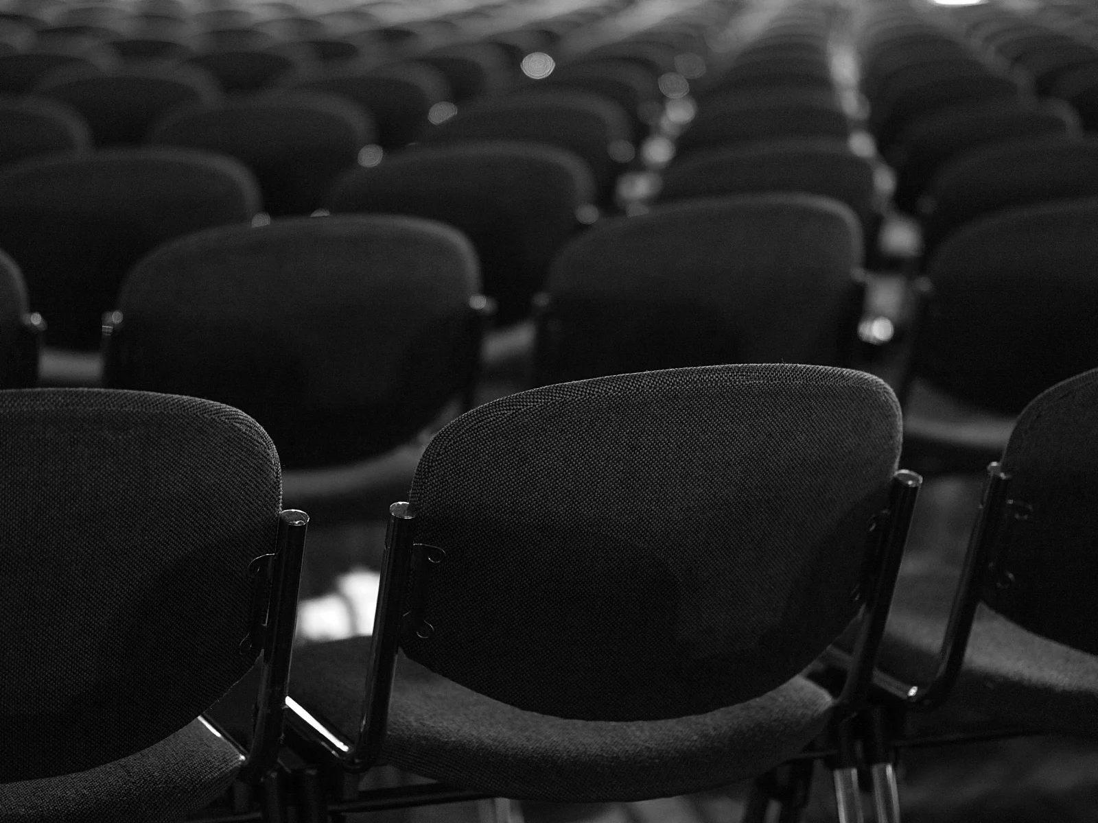 Empty conference chairs in black unsplash.jpg