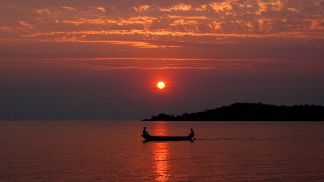 Lake Shore Lodge Tz - Lake Tanganyika - Activities - Sunset Cruise - Red sunset with local boat.JPG