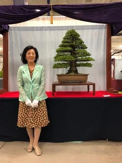 Mrs. Naemi Iwasaki stands with Kokonoe