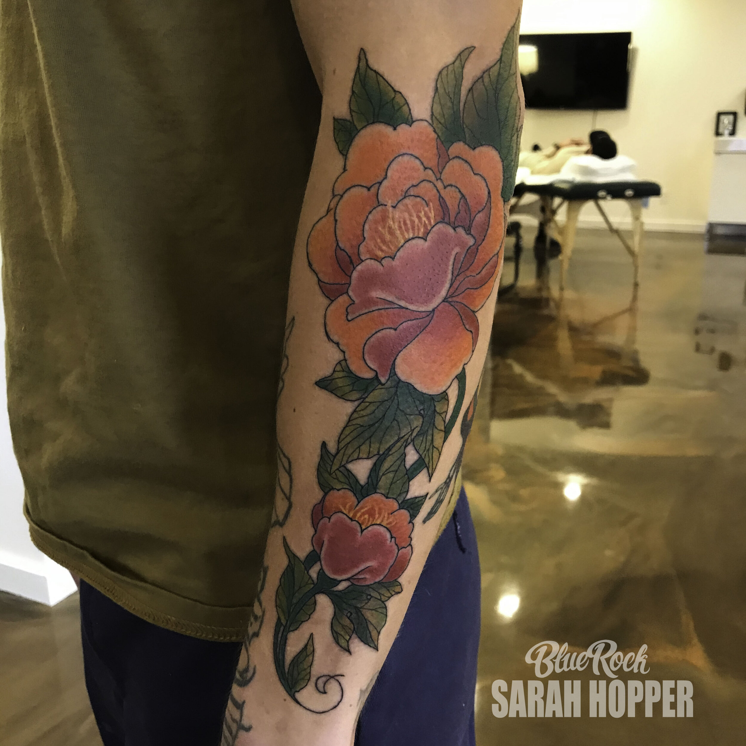 Traditional style peony tattoo on the left forearm