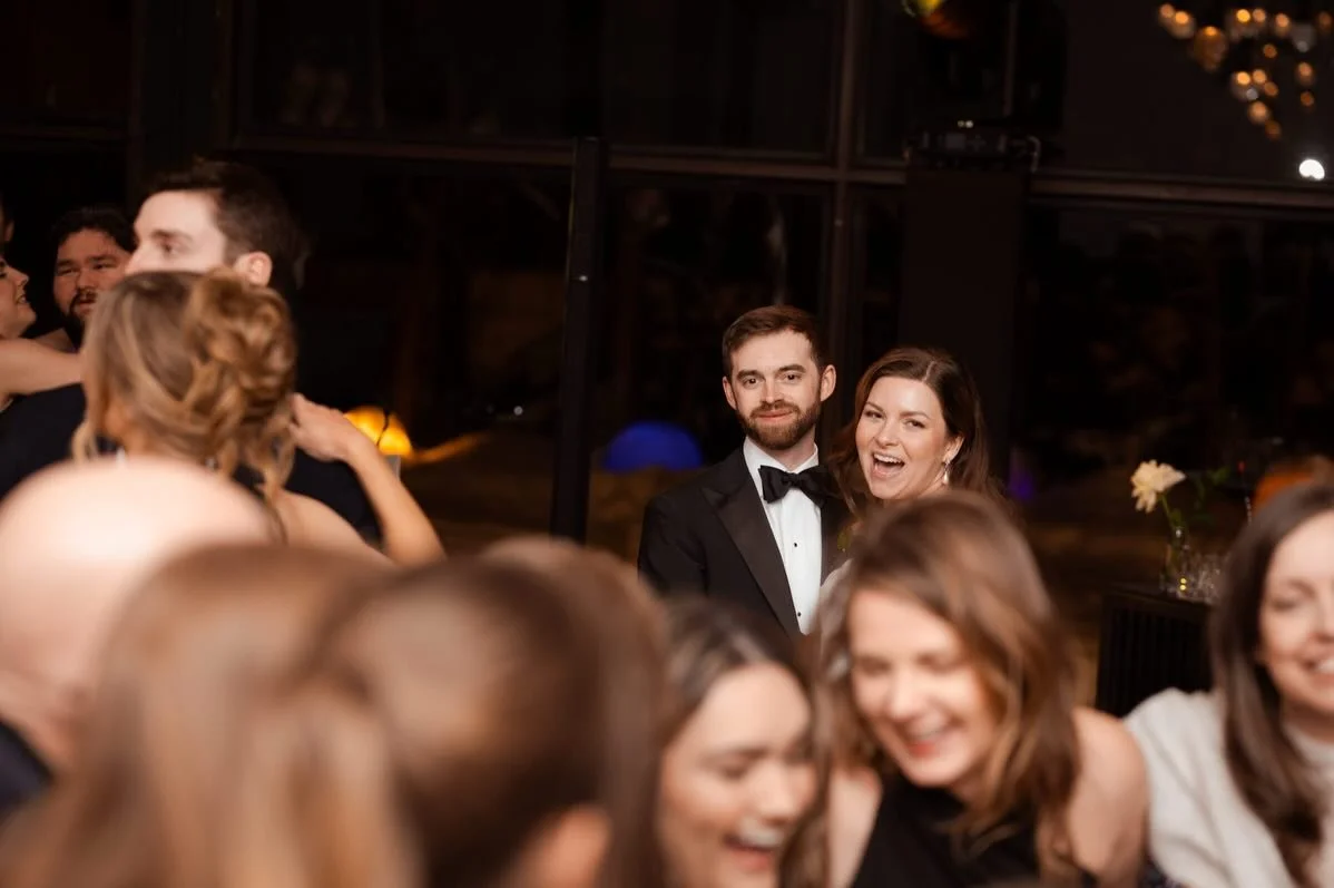 Had I not jumped up on a chair during Emily &amp; Austin&rsquo;s wedding reception, I might have missed this serendipitous moment of the newlyweds being fully present and captivated by their family members sharing an arm in arm circle on the dance fl