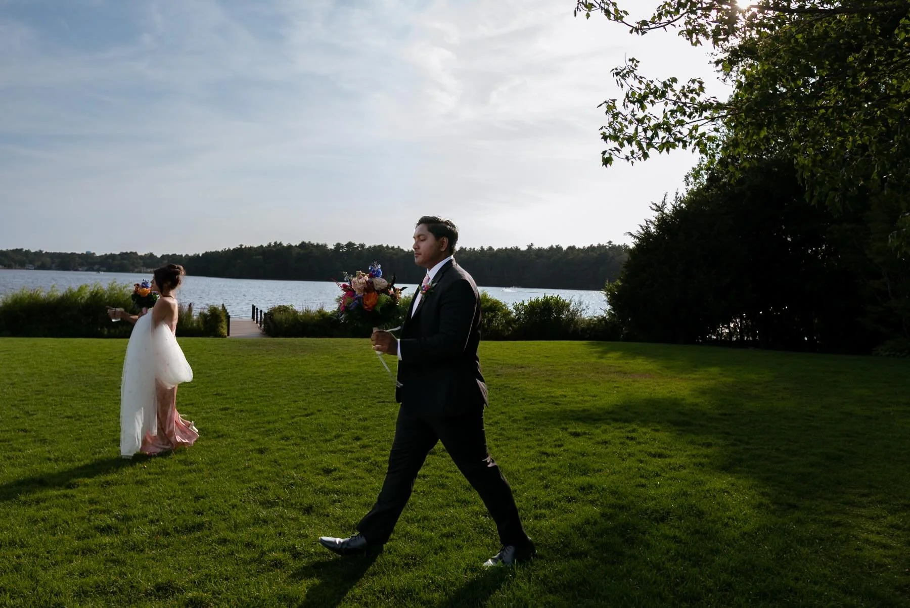 Securing the veil and bouquet across the lawn by a sparkling lake, under a perfectly blue late afternoon sky in the month of August. 

It&rsquo;s in these quick understated candid moments of a wedding day that need not be written into the timeline, b