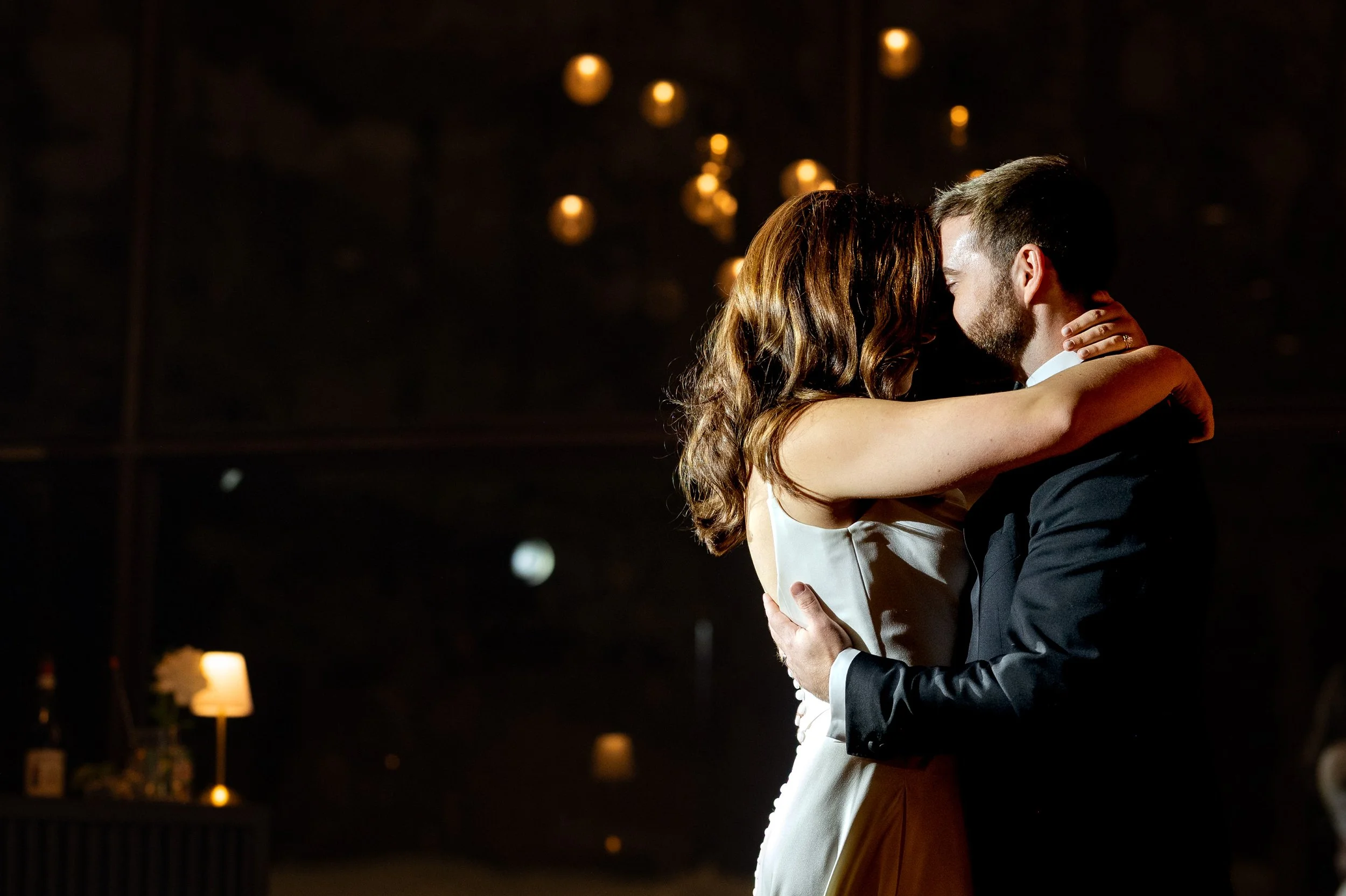 Bride and groom embrace, foreheads touching while they dance at La Toundra, Montreal, Quebec, Canada. 