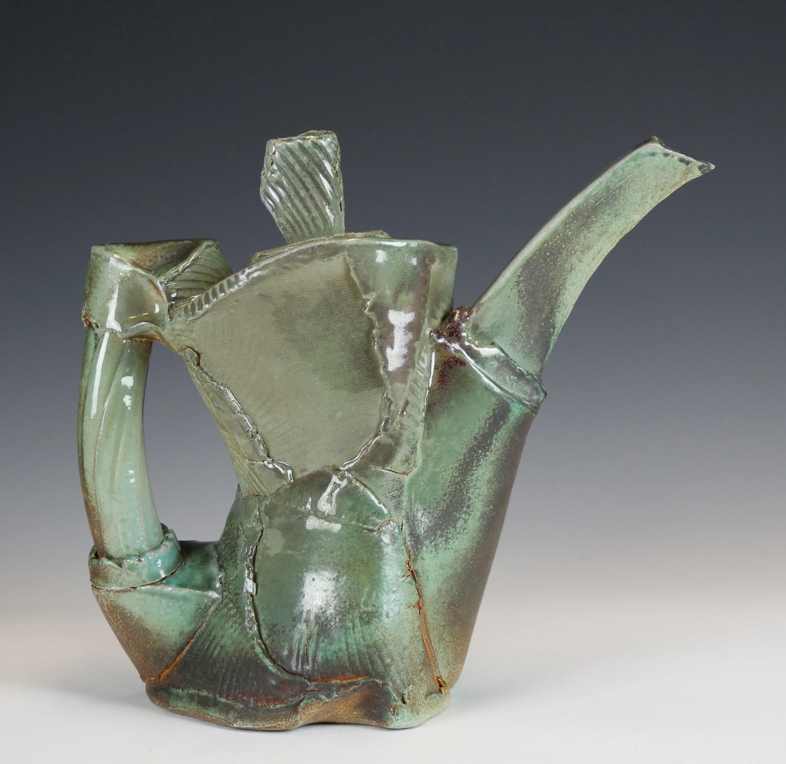  Soda fired Stoneware fired in reduction to cone 10. Hand built with overlapping, wrapped and impressed slabs, 14”t X 14”l X 6” w. 