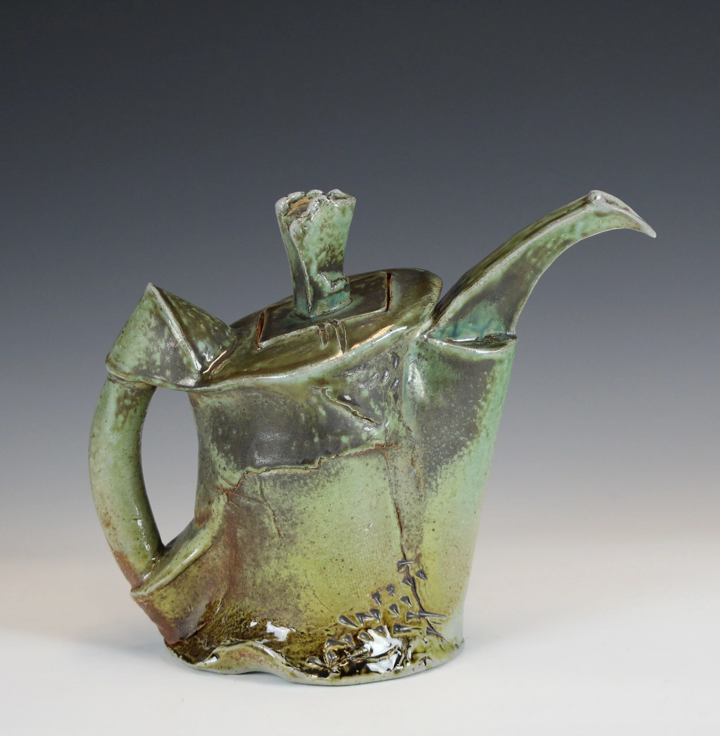  Soda fired Stoneware fired in reduction to cone 10. Hand built with overlapping, wrapped and impressed slabs, 10”t X 11.5”l X 5.5”w  Awarded the Bruce Chesser Award for Ceramics,”64 Annual Spring Show 2019”, Art Space Lima, Lima Ohio, 