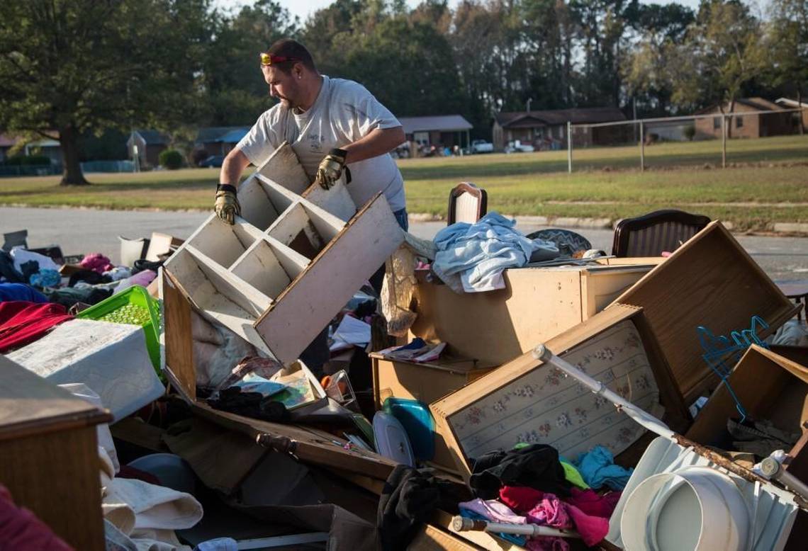 A Lumberton resident works to gut homes and remove debris after Hurricane Matthew. (Photo Credit Unknown)