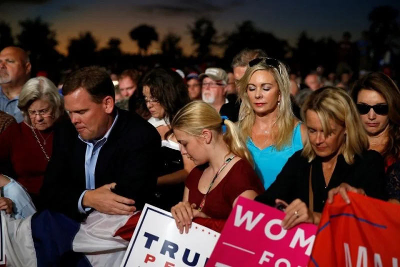 (Carlo Allegri/REUTERS) White evangelicals pray at a Trump rally in Florida.