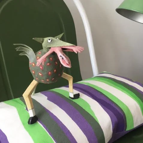 A creature jumping on my Spring Sunshine cushion