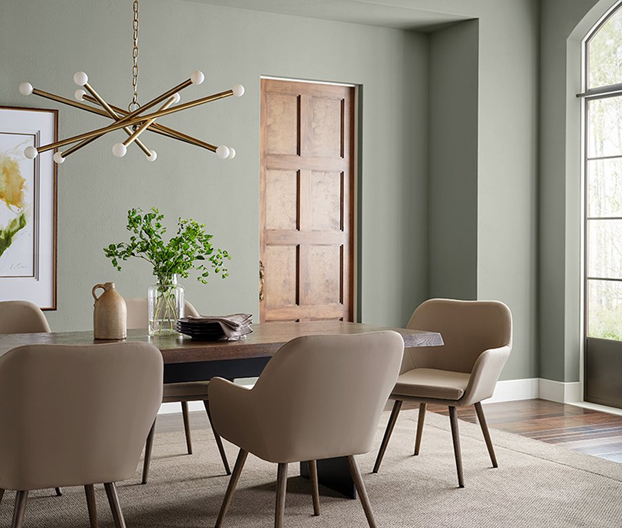  A modern dining room with Sherwin-Williams' 2022 Color of the Year, Evergreen Fog. 