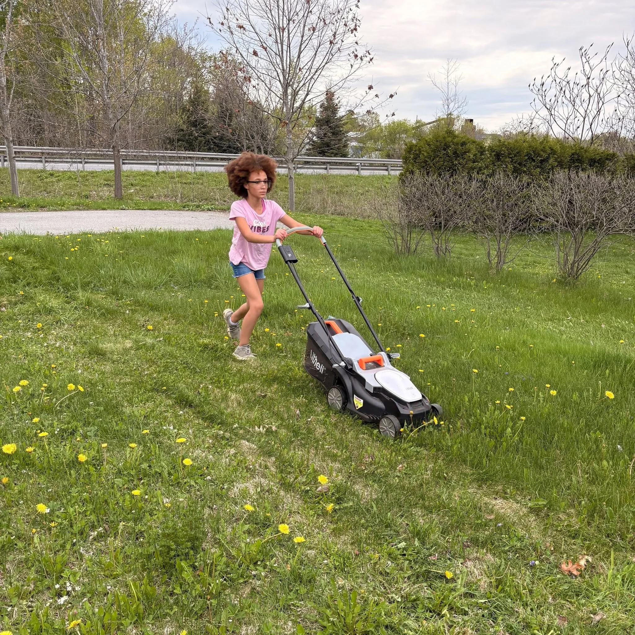 Elizabeth mowing the lawn
