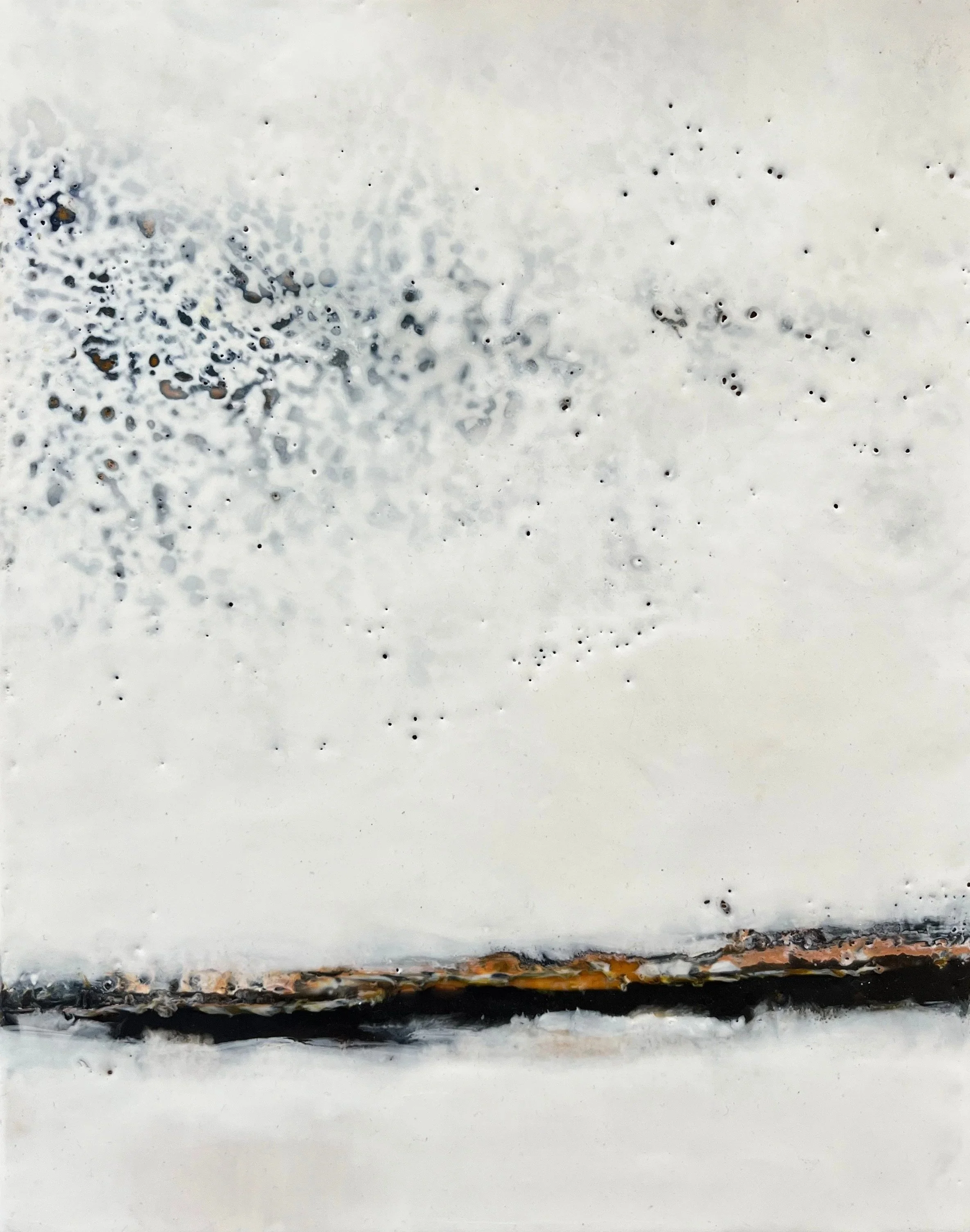 Close-up view of a layered surface with a white top layer, a middle rusty black layer, and an uneven rusty bottom layer.
