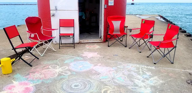 A calm moment before the public rolled in on the last day of the exhibit: Matching red chairs and a bunch of sidewalk chalks were kindly provided. And as you can see by the mural on the ground, they were put to productive use by creatives who stopped by throughout the week! It truly turned into a magical community event.