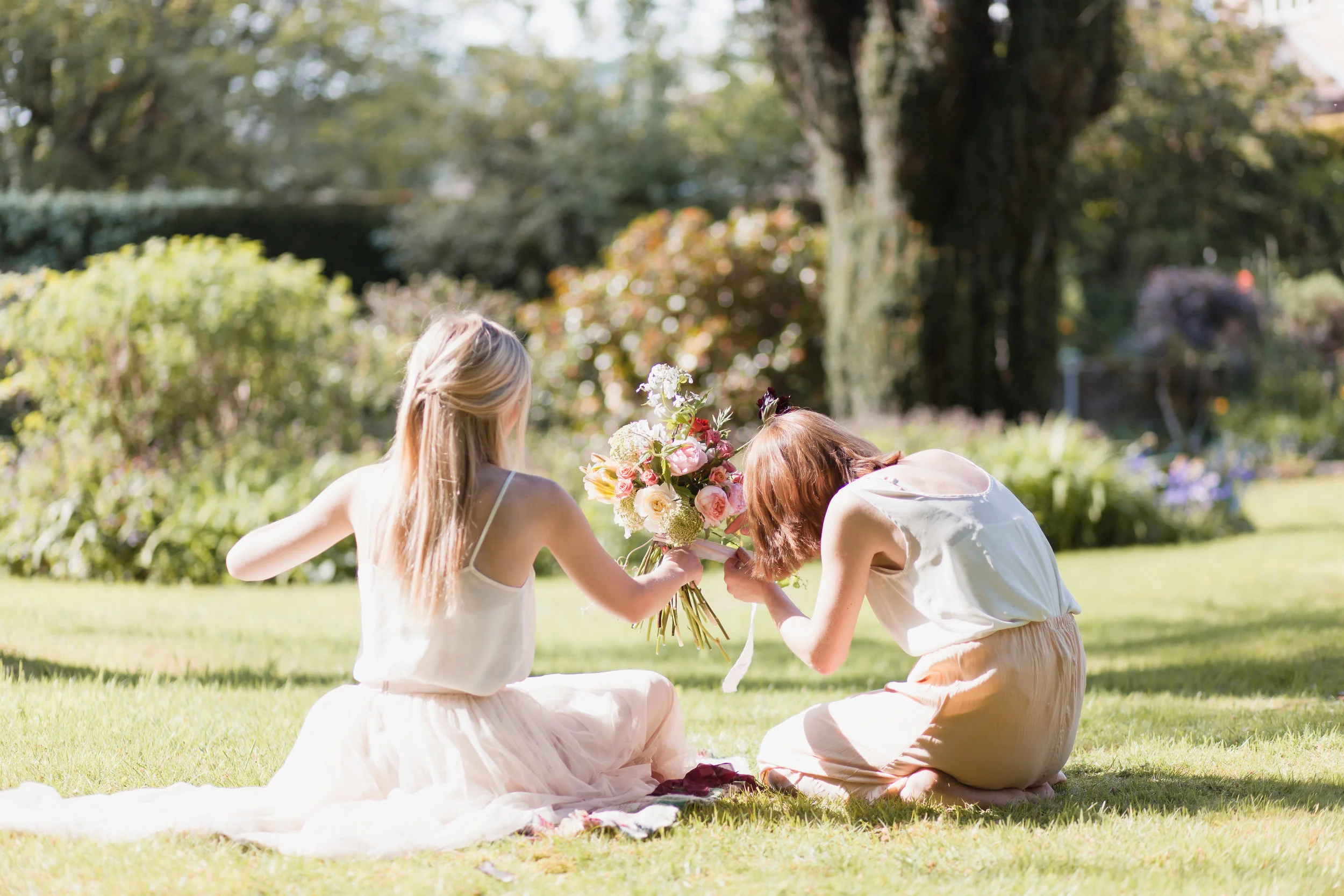 Charlotte (right) attaching silk ribbon to a bouquet! Photo courtesy of Charlotte Palazzo Photography.