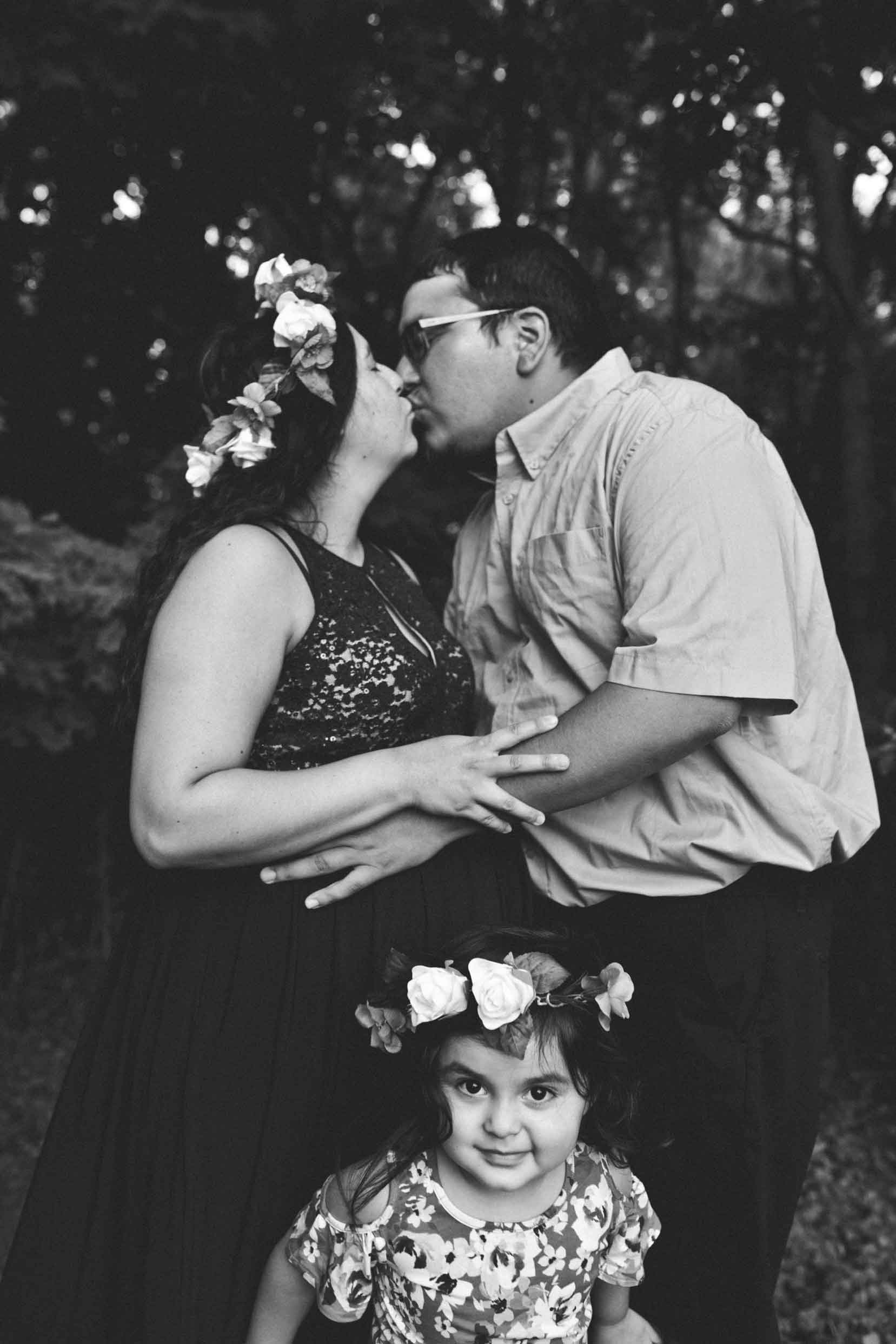 mom-and-dad-kiss-girl-wearning-floral-crown-hamilton.jpg