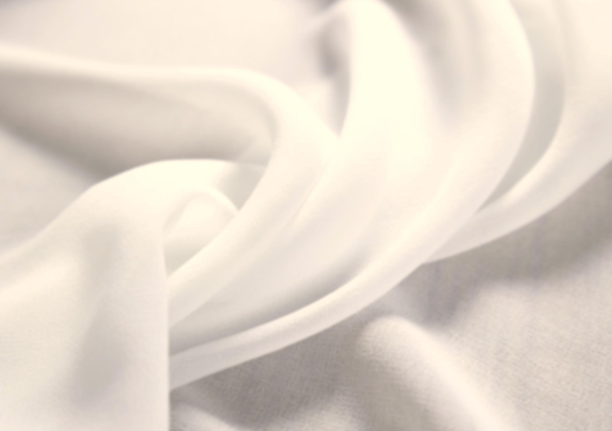 Close-up of smooth, white silk fabric with gentle folds.