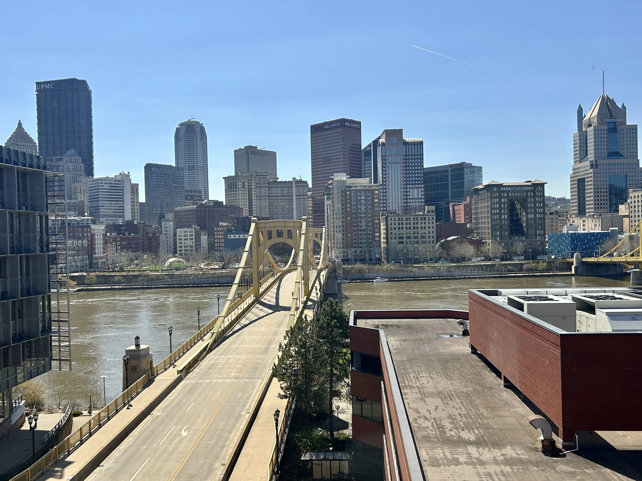 a photograph of a bridge going over a river, heading into downtown Pittsburgh