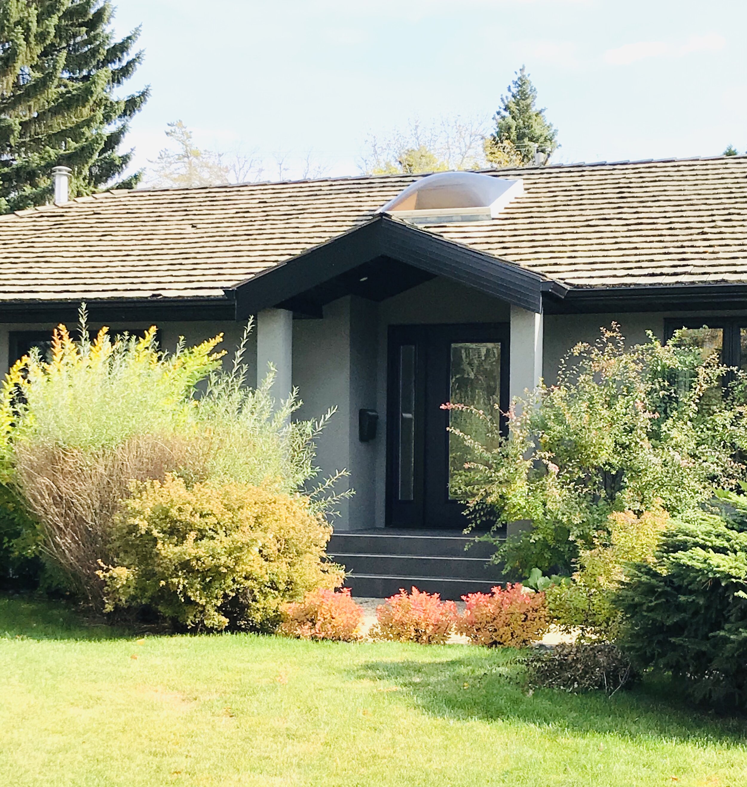 Exterior-Renovation-Grey Stucco-Grey Siding-Black Trim-Purple Front Door-Style Maven Decor Interior Design-Edmonton Canada