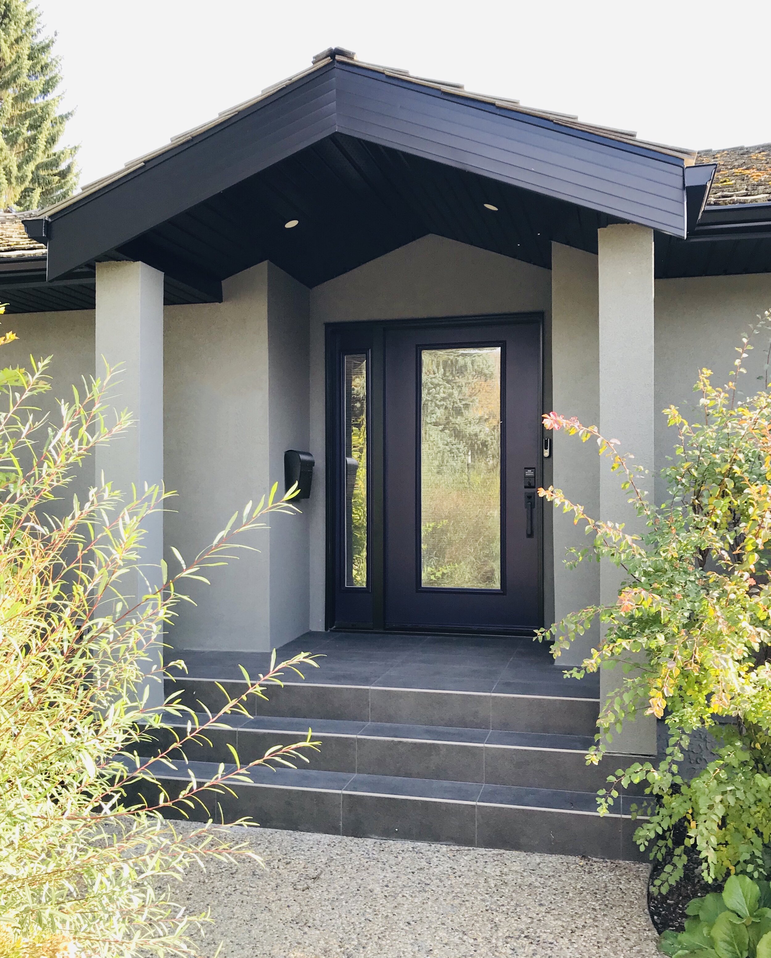Exterior-Renovation-Grey Stucco-Tile-Front Step-Purple Door-Style Maven Decor Interior Design-Edmonton Canada