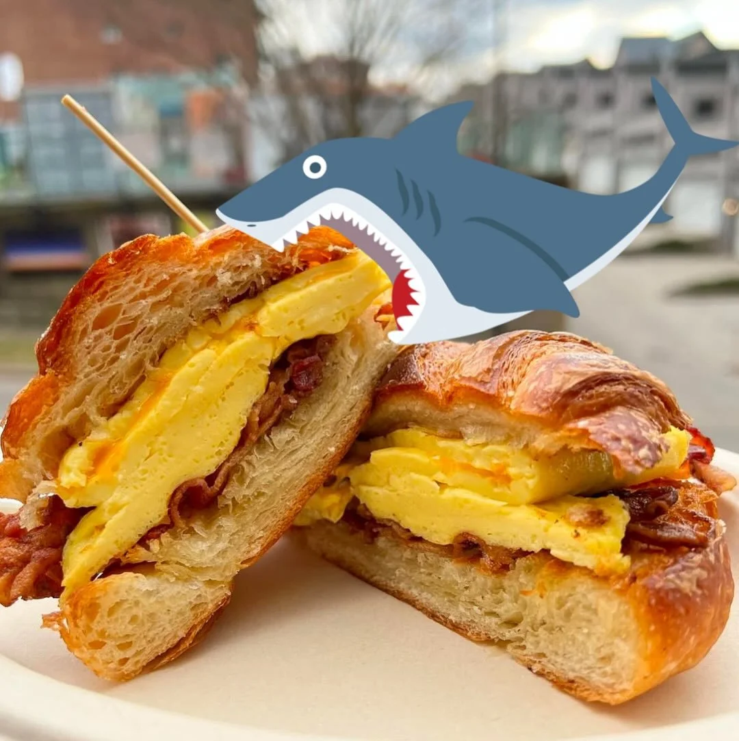 Somebody ordered a croissant egg&rsquo;wich but our new employee Nomz the Shark got ahold of it 😔 Hope you don&rsquo;t mind the NOM marks, he&rsquo;s doing his best. 

It&rsquo;s officially SHARK WEEK 2025 at 11:30PM tonight! Come get in the mood fo