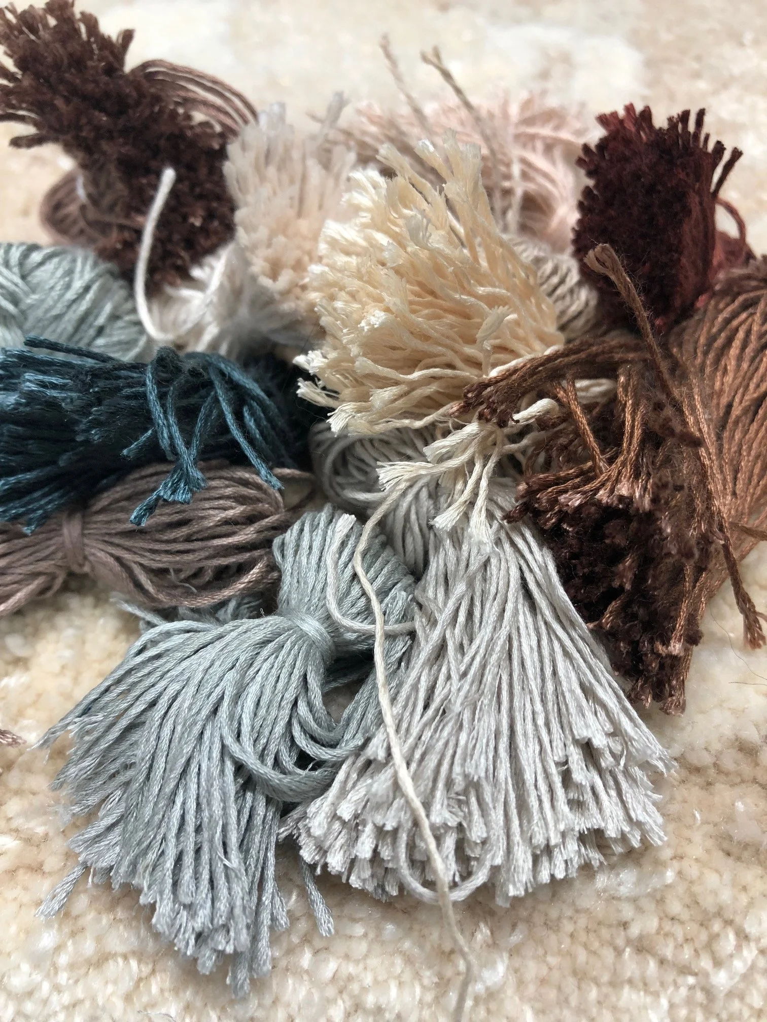 detail of Manufacture Pinton color swatches showing browns, cream, gray, blue wool and silk tufts