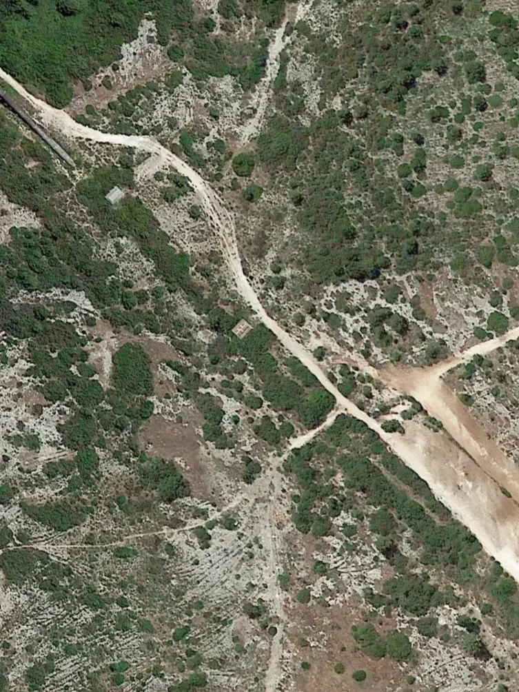 Satellite view of a semi-arid landscape with green brush and winding dirt roads. This aerial perspective serves as the initial reference for the Tangible Archives: Epoch rug by Edouard Sankowski, woven at Manufacture Pinton.