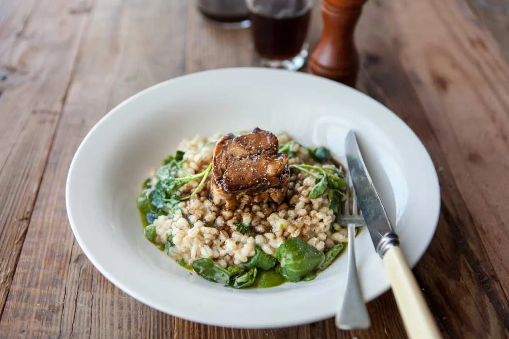 Slow-cooked pork with pesto and pearl barley risotto